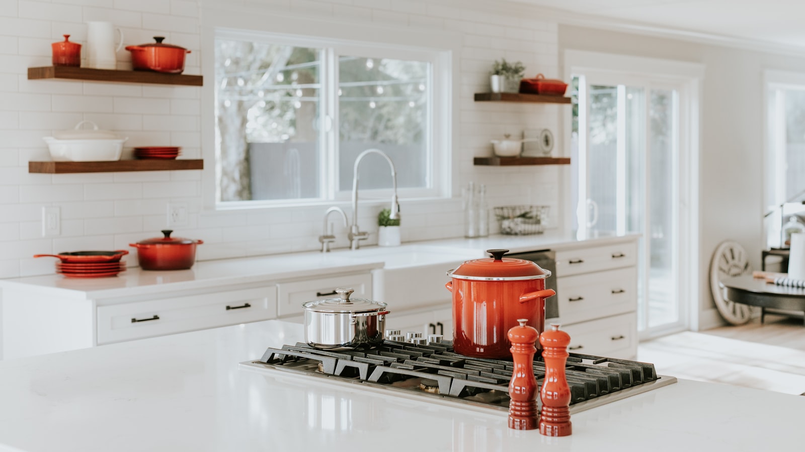 A tidy kitchen counter with a clean cutting board, a bowl of prepped ingredients, and a soapy sink.