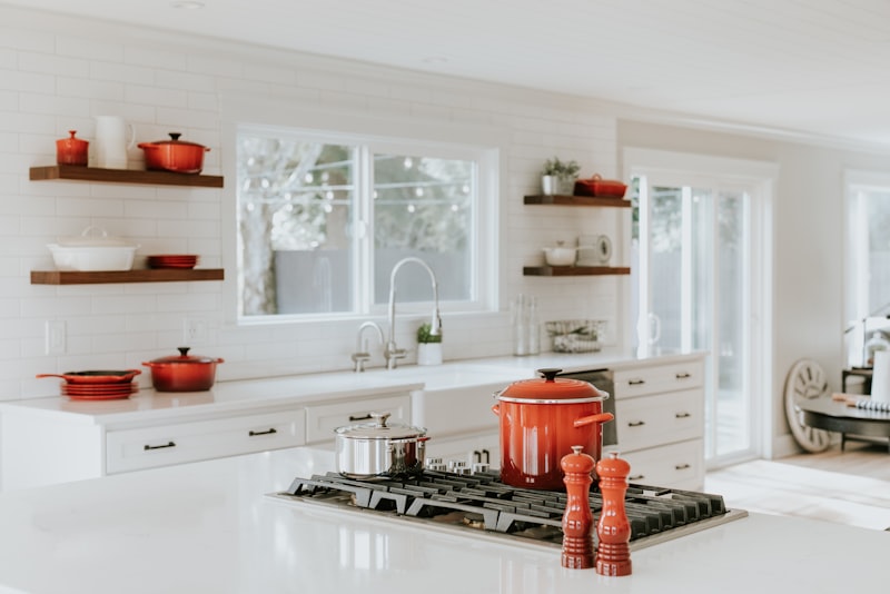 A tidy kitchen counter with a clean cutting board, a bowl of prepped ingredients, and a soapy sink.